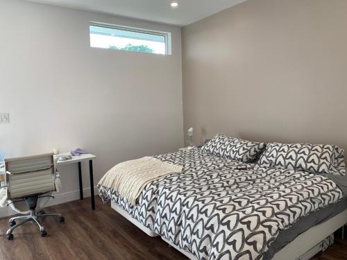 a bedroom with a bed and a desk and a window at Biscayne Garden's Studio in Miami