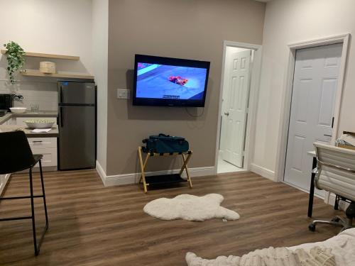 a living room with a flat screen tv on the wall at Biscayne Garden's Studio in Miami