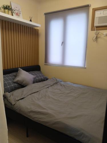 C516 Place at SMDC Cheer Residences by Lee Portumにあるベッド