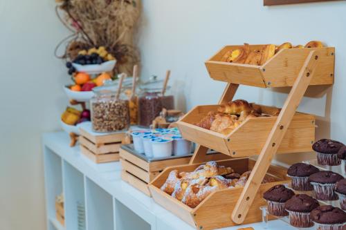 a shelf with several boxes of different types of pastries at Hotel Windrose in Rome