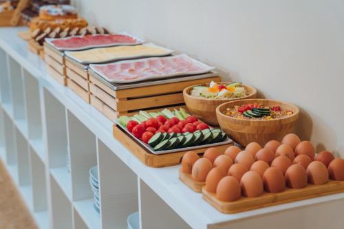 a buffet of food with eggs and vegetables on a table at Hotel Windrose in Rome