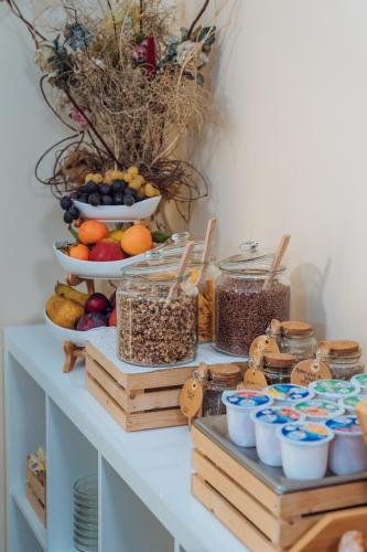 a table with bowls of fruit and other foods at Hotel Windrose in Rome
