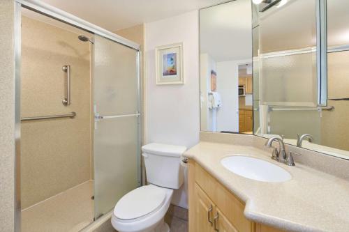 a bathroom with a toilet and a shower and a sink at Ilikai Lite in Honolulu