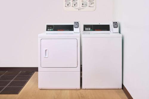 two white refrigerators sitting next to a wall at Ilikai Lite in Honolulu
