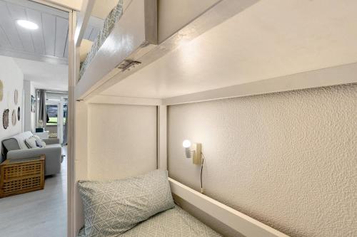 a living room with a couch and a lamp on a wall at Tróia Beach House in Carvalhal