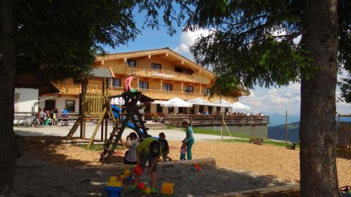 a group of children playing on a playground at Berggasthof Schatzbergalm in Thierbach