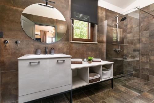 a bathroom with a sink and a mirror and a shower at Villa Valma by IstriaLux in Svetvinčenat