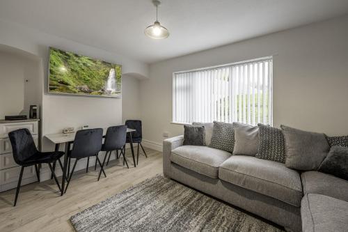 a living room with a couch and a table at Ridge Grove Lodge "Sleeping 4 guests" 