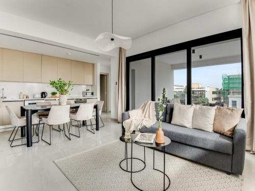 a living room with a couch and a table at Sanders Premier Downtown in Limassol