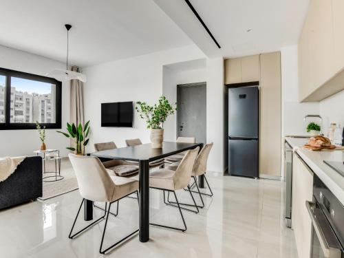 a kitchen and dining room with a table and chairs at Sanders Premier Downtown in Limassol