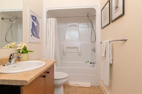 a bathroom with a sink and a toilet and a shower at Modern Heritage Studio With Murphy Bed in Victoria