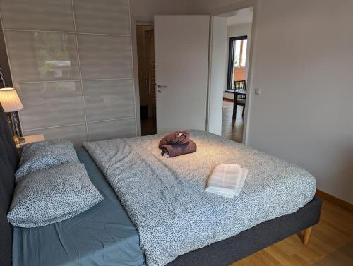 a dog laying on a bed in a room at 1 Bedroom Apartment with Garage & Outdoor Area in Kirchberg in Luxembourg