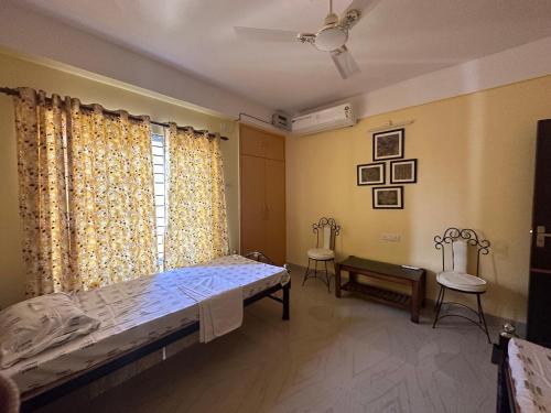 a bedroom with a bed and a window at Sneha’s Happy Home. in Guwahati