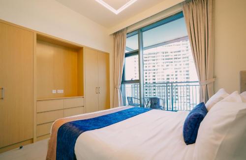 a bedroom with a bed and a large window at CitiHome-2BR creek harbour island in Dubai