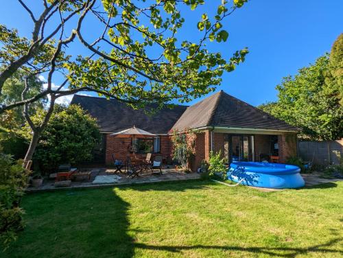 a brick house with a blue tub in the yard at Cosy Garden View Room in East Grinstead