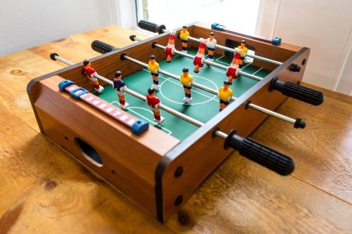 a wooden foosball table with toy men playing a game at Beach in Reach in Eastbourne