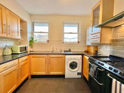 a kitchen with a washer and a dishwasher at Kanangra, 2 bedroom apartment in Teignmouth in Teignmouth