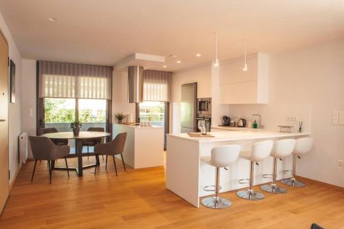 a kitchen and dining room with a table and chairs at Voula Luxury Apartment in Athens