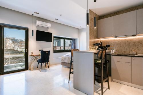 a kitchen and living room with a table and chairs at Royalty Suites Psyrri in Athens