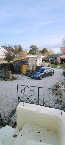 a blue car parked in a parking lot at Studio Propre et Cosy in Le Mesnil-en-Vallée