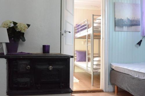a room with a bedroom with a bed and a staircase at Årsunda Strandbad Sjösunda vandrarhem in Årsunda
