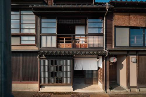 an external view of a building with a gate at 空知 -Koochi- in Kanazawa