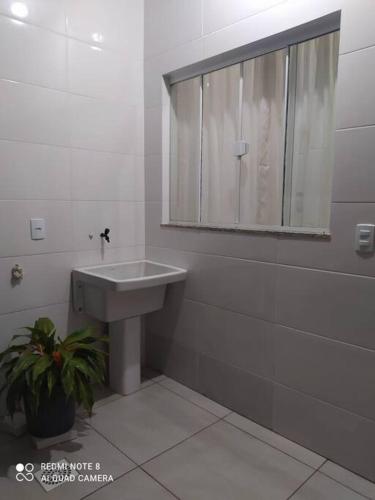 a bathroom with a sink and a mirror at Casa praia em Penha - disponível in Penha