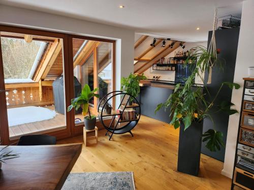 a room with potted plants and a kitchen at Exclusive 120 qm Wohnung am Wössner in Unterwössen