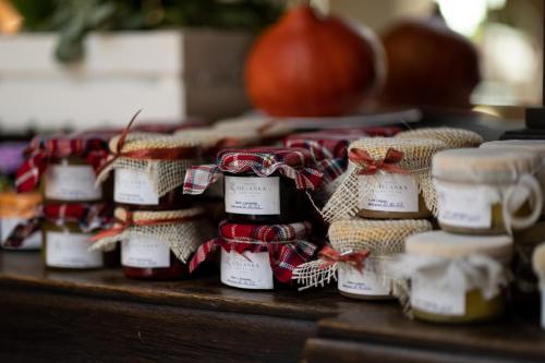 a group of jam jars on a table with bows at Sielanka Nad Pilicą in Warka
