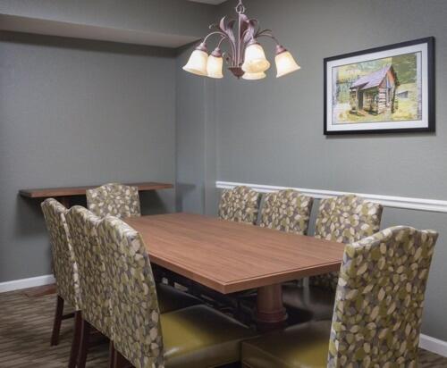 a dining room with a wooden table and chairs at Club Wyndham Smoky Mountains in Pigeon Forge