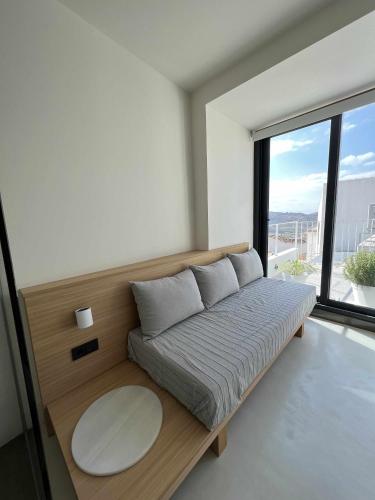 a bed in a room with a large window at Casabell 3 - Caminito del Rey in Valle de Abdalagís