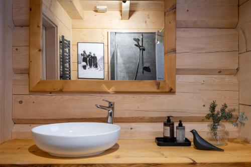 a bathroom with a white sink and a mirror at udanypobyt Tatrzańskie Domy in Kościelisko