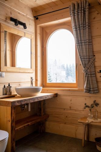a bathroom with a sink and two windows at udanypobyt Tatrzańskie Domy in Kościelisko