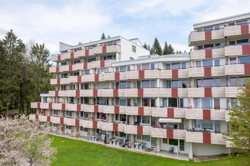 an apartment building with red and white balconies at Ferienvermietung Sporer in Sankt Englmar