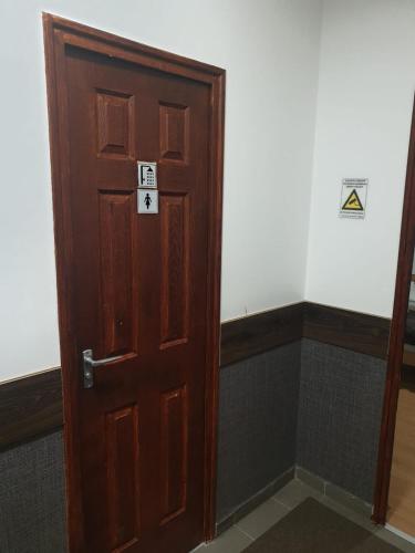 a wooden door in a room with signs on it at Allaga City Center in Budapest