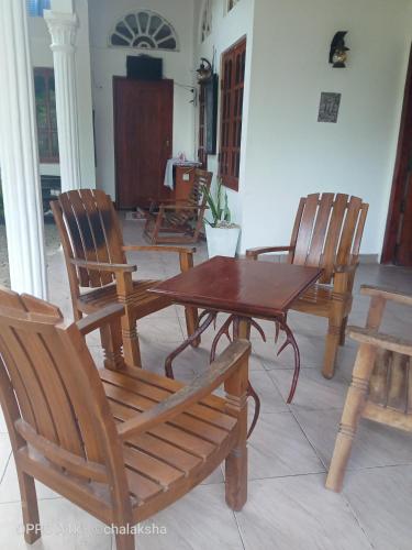 a dining room with a wooden table and chairs at Sidhangana Home Stay in Anuradhapura