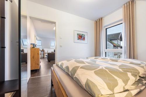 a bedroom with a bed and a large window at Ferienwohnung Lampa in Wasbüttel