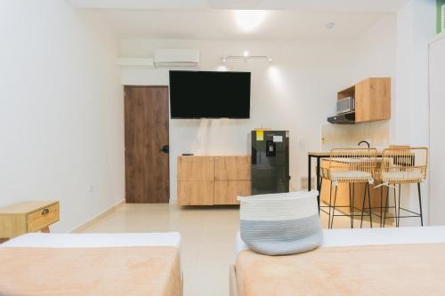 a living room with a tv and a table at La Casona Hotel Boutique in Medellín