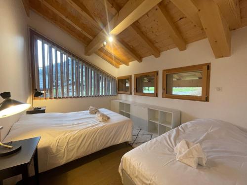 a bedroom with two beds and a desk and windows at Chalet Sixt-Fer-à-Cheval, 6 pièces, 13 personnes - FR-1-624-132 in Sixt