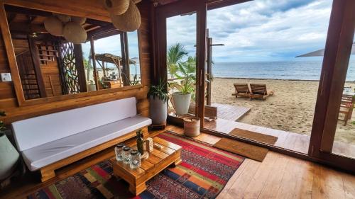 ein Wohnzimmer mit einem Sofa und Strandblick in der Unterkunft Yaku Hostel in Playa Mendiguaca