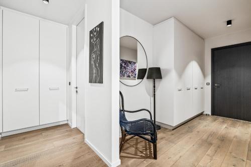 a hallway with a chair and a mirror at Unbeatable Central Location - Reykjavíks Most Exclusive Luxury Apartments in Reykjavík