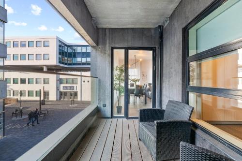 a balcony with chairs and a view of a building at Unbeatable Central Location - Reykjavíks Most Exclusive Luxury Apartments in Reykjavík