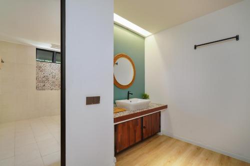 a bathroom with a sink and a mirror at Villapadu Bayu in Kuala Terengganu