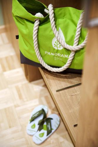 a green bag with a pair of sandals next to it at Bio-Seehotel Zeulenroda in Zeulenroda