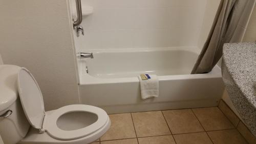 a bathroom with a toilet and a bath tub at Motel 6-Eagle Pass, TX - Lakeside in Eagle Pass