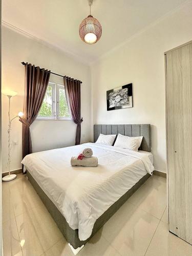 - une chambre avec un grand lit blanc et une fenêtre dans l'établissement Guest house Star No.1, à Bedahulu