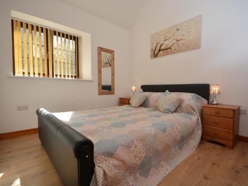 a bedroom with a bed and a dresser and a window at 2 bed property in Bath 72837 in Chew Magna