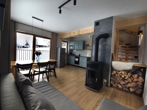 a living room with a couch and a fire place at Galicówka na Górce Domki in Biały Dunajec