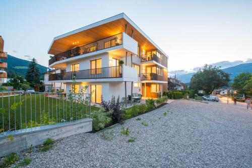a large house with a fence in front of it at Apartment Edelweiss in Brunico