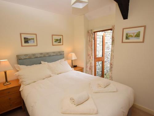 a bedroom with a large white bed with towels on it at 1 Bed in Wolsingham 36674 in Wolsingham